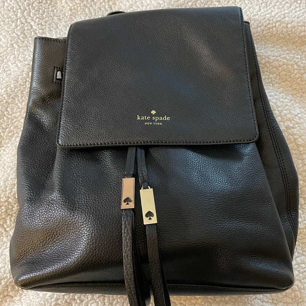Kate Spade backpack with gold charm embellishments